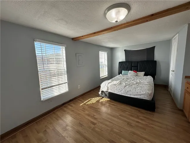 a bedroom with a bed and window