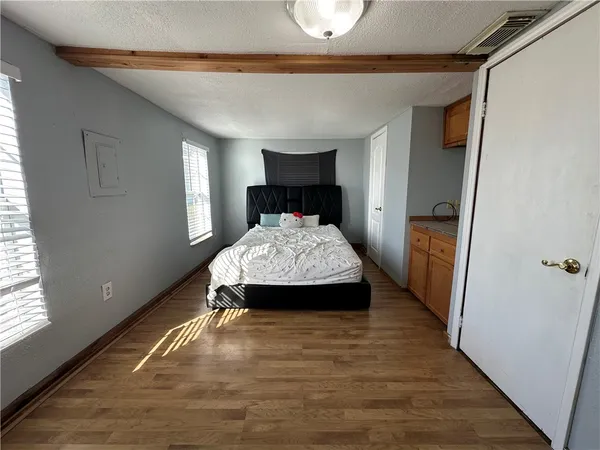 a bedroom with a bed and a mirror on dresser