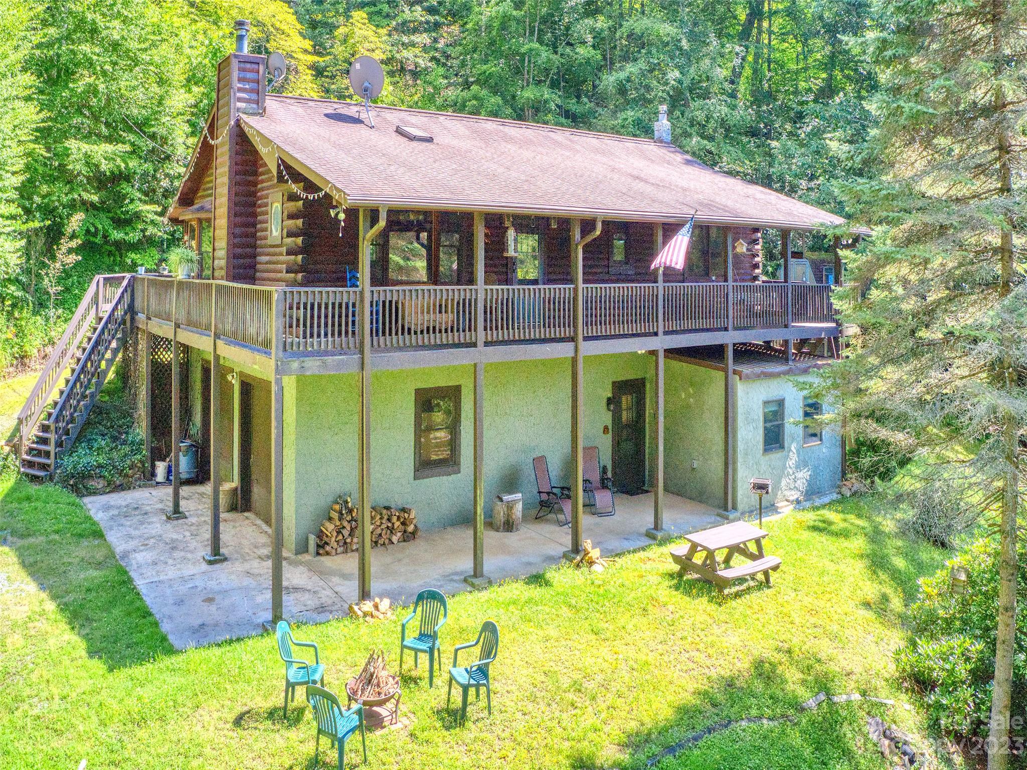 a view of a house with a backyard patio and swimming pool
