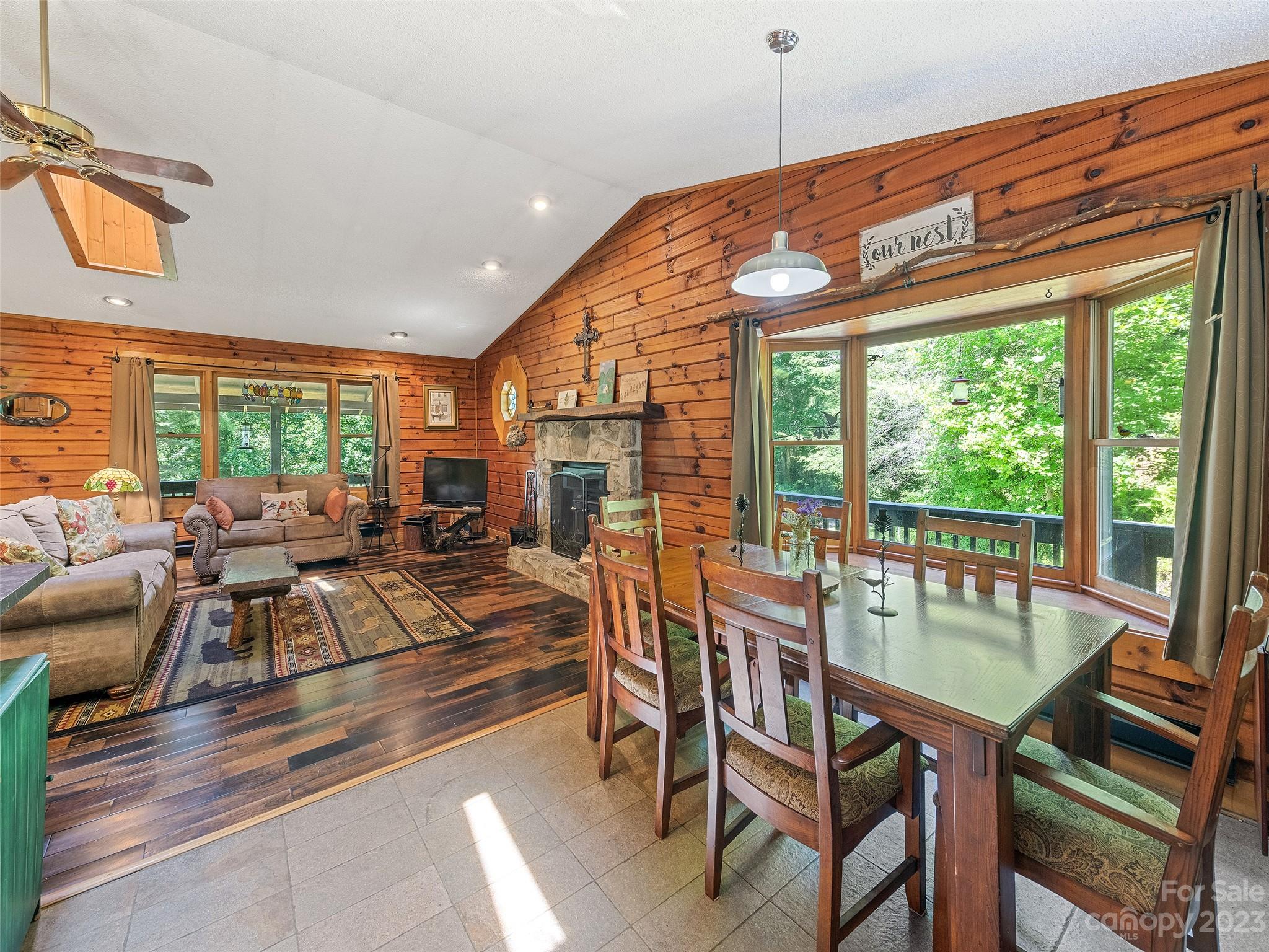 28 Honeybear Lane Clyde, NC 28721 - Photo 11 of 43 a dining room with furniture a chandelier and wooden floor