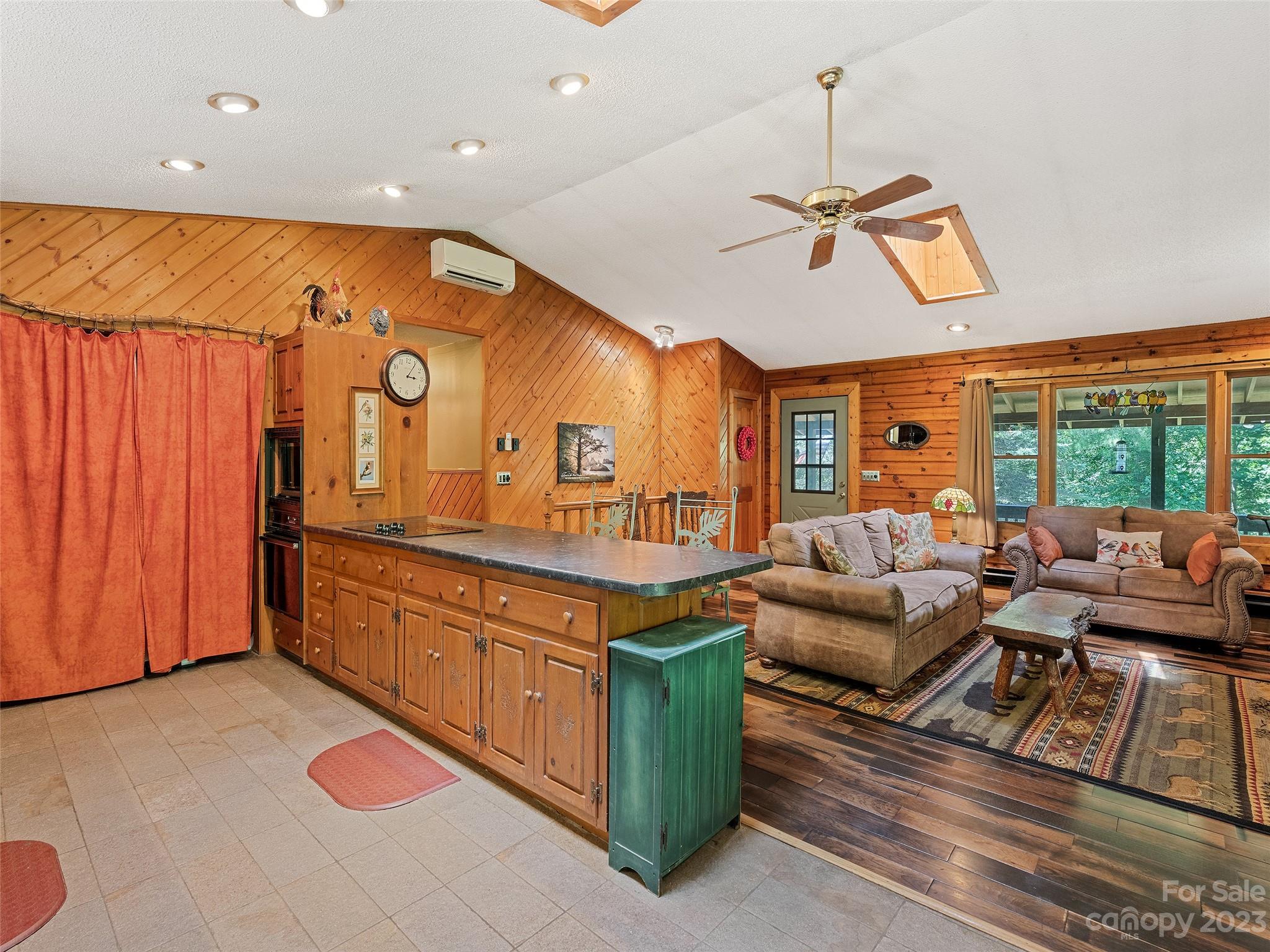 28 Honeybear Lane Clyde, NC 28721 - Photo 14 of 43 a living room with furniture a rug and a chandelier