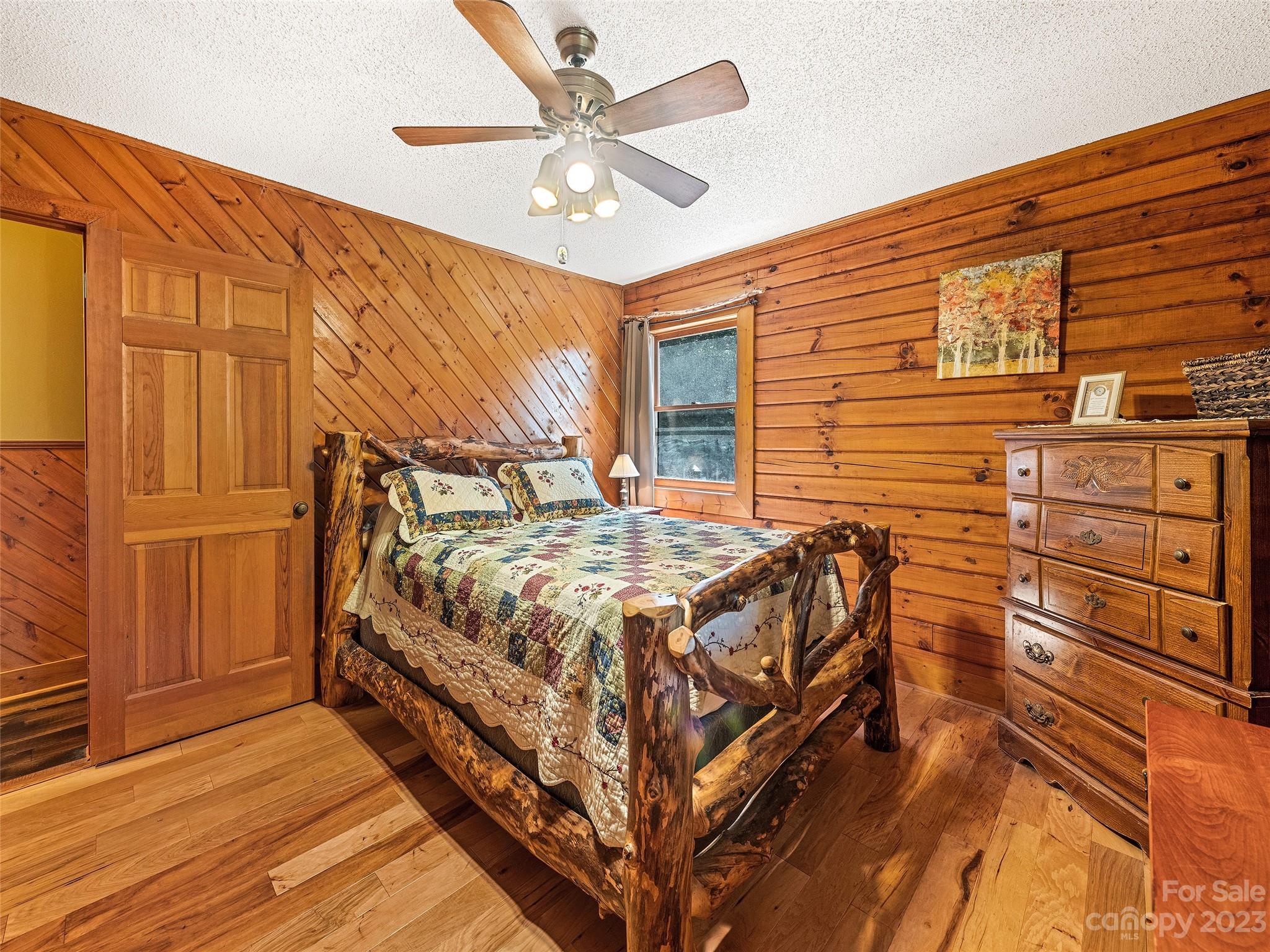 28 Honeybear Lane Clyde, NC 28721 - Photo 18 of 43 a bedroom with a bed and a chandelier