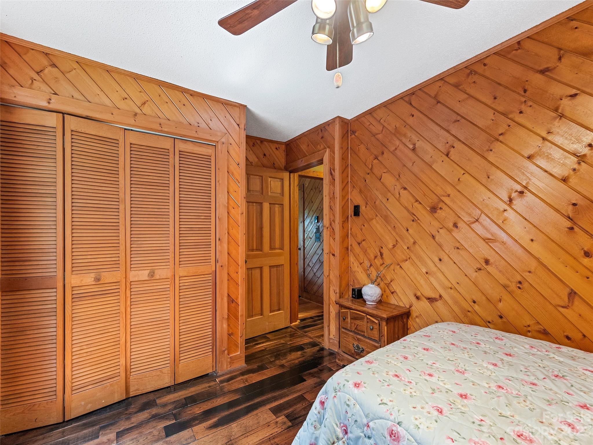 28 Honeybear Lane Clyde, NC 28721 - Photo 22 of 43 a bedroom with a bed and wooden floor