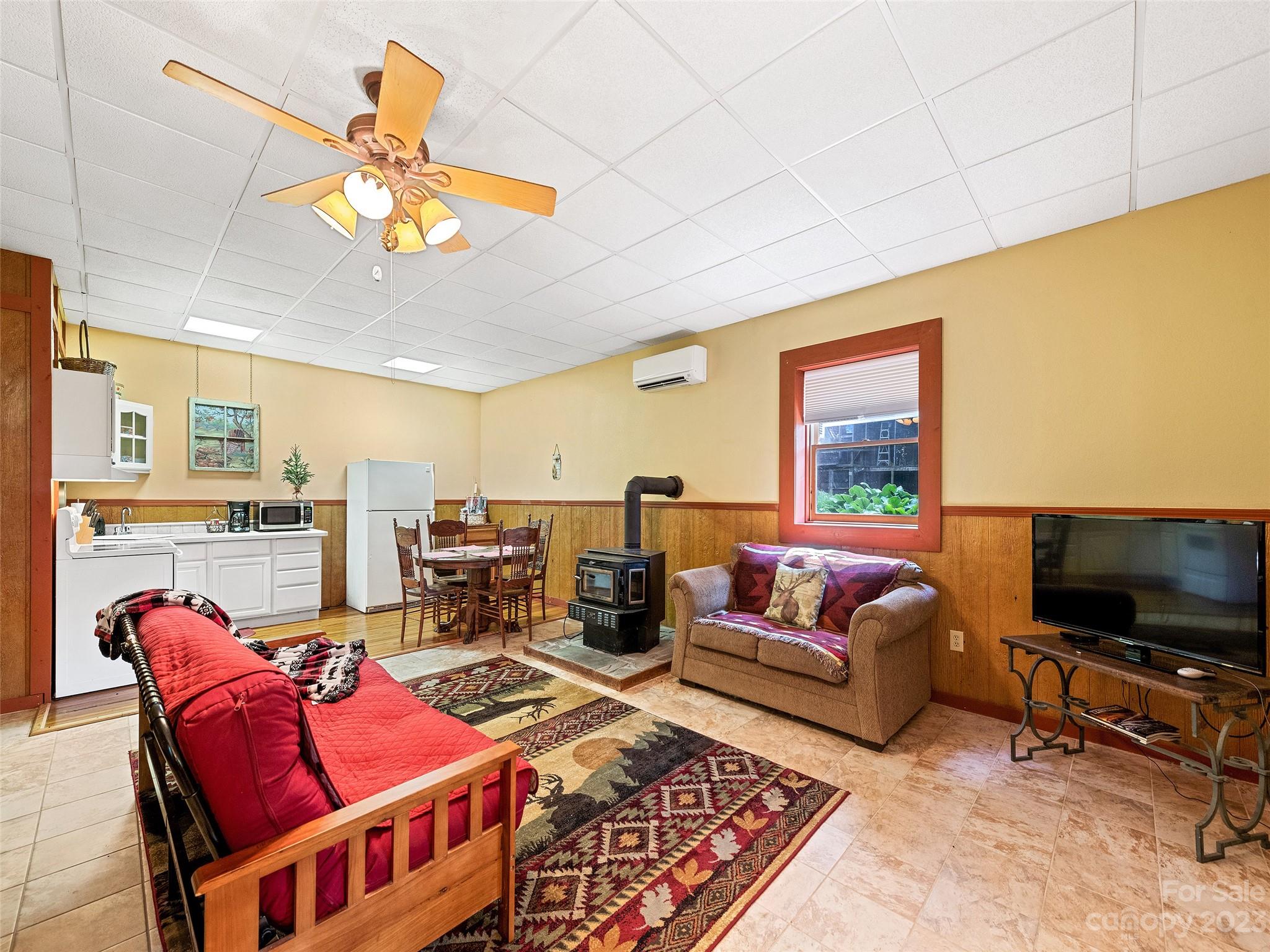 28 Honeybear Lane Clyde, NC 28721 - Photo 24 of 43 a living room with furniture a flat screen tv and kitchen view