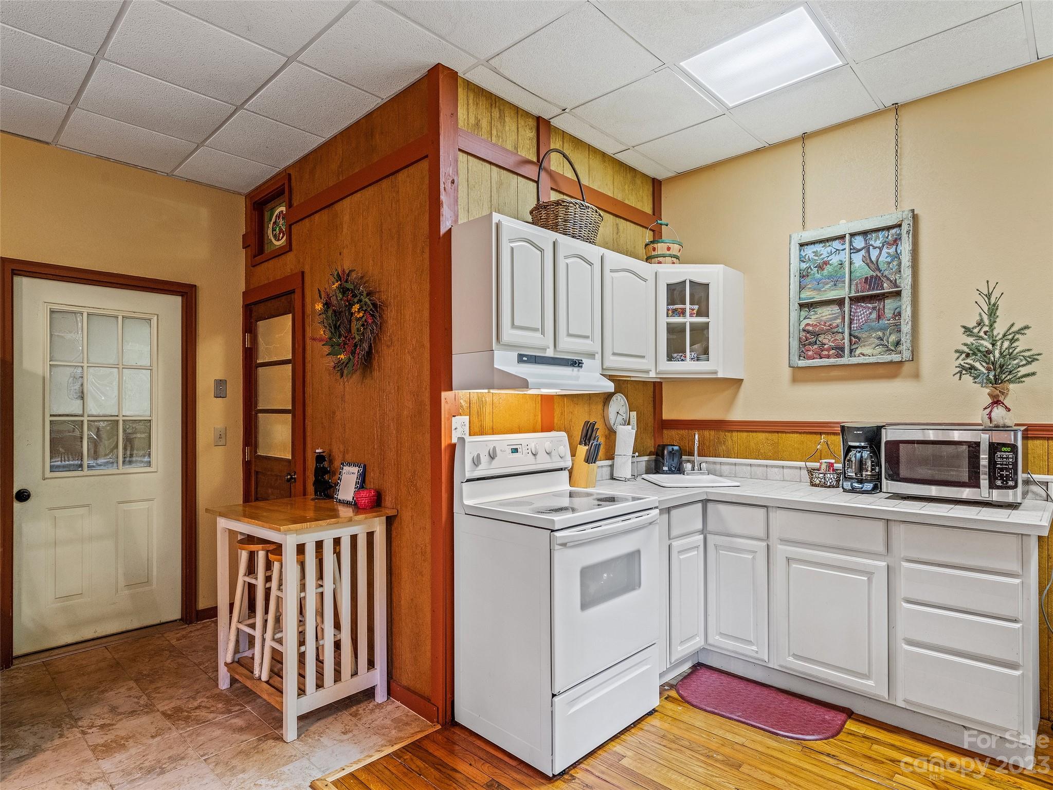 28 Honeybear Lane Clyde, NC 28721 - Photo 29 of 43 a kitchen that has a lot of cabinets in it and wooden floors