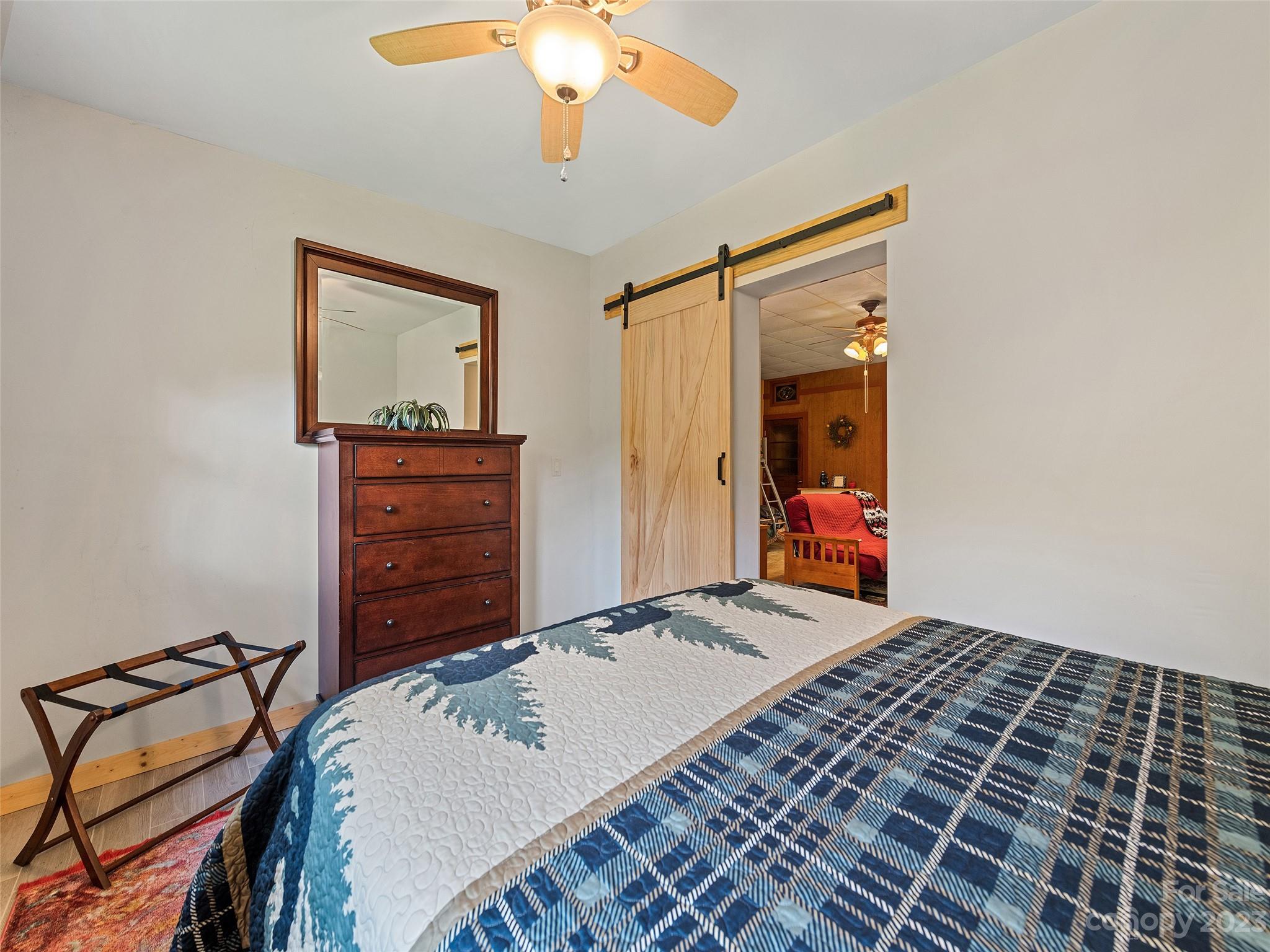 28 Honeybear Lane Clyde, NC 28721 - Photo 31 of 43 a bedroom with a bed and a chandelier