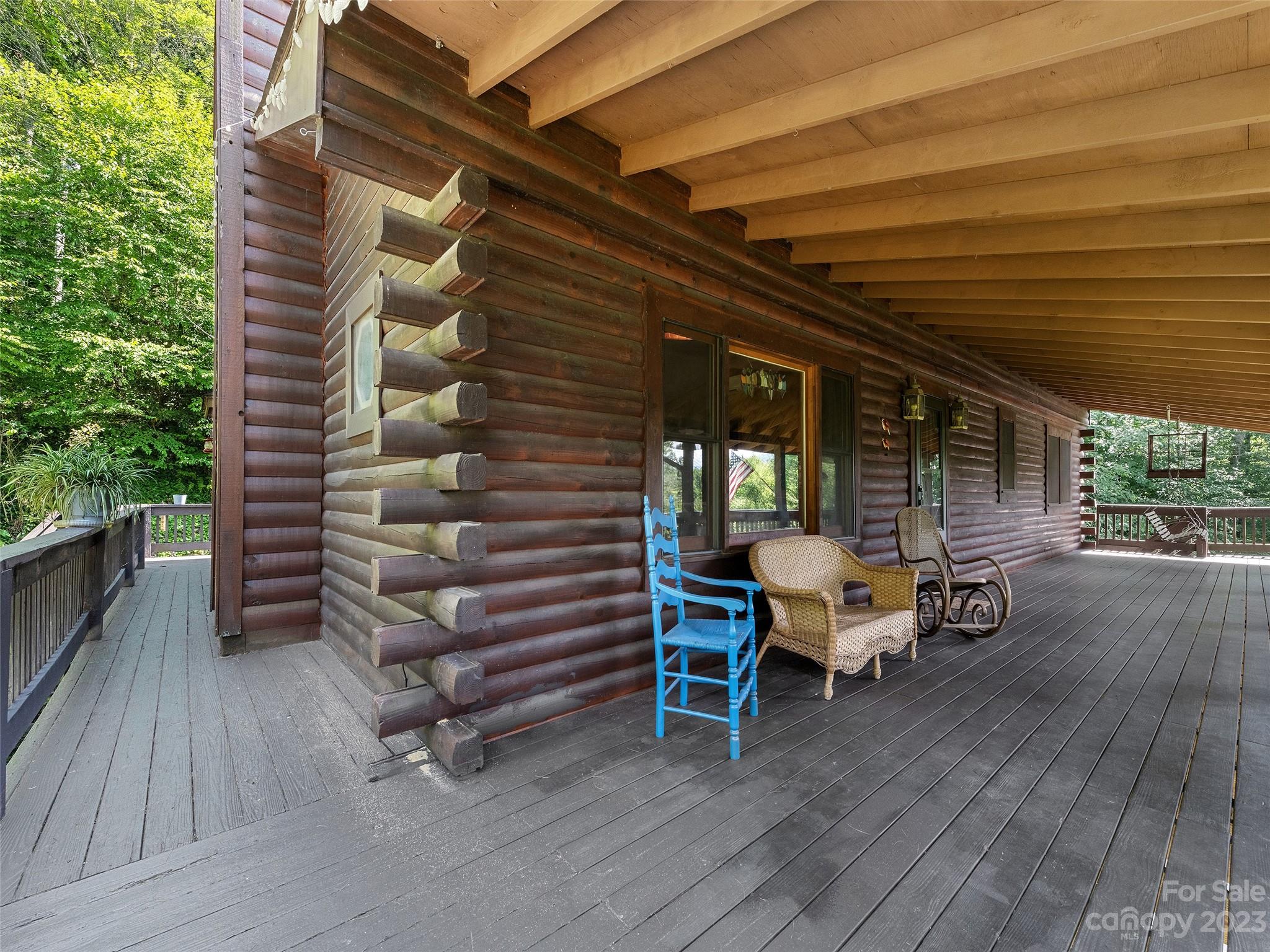 28 Honeybear Lane Clyde, NC 28721 - Photo 34 of 43 a view of a patio with table and chairs with wooden floor and fence