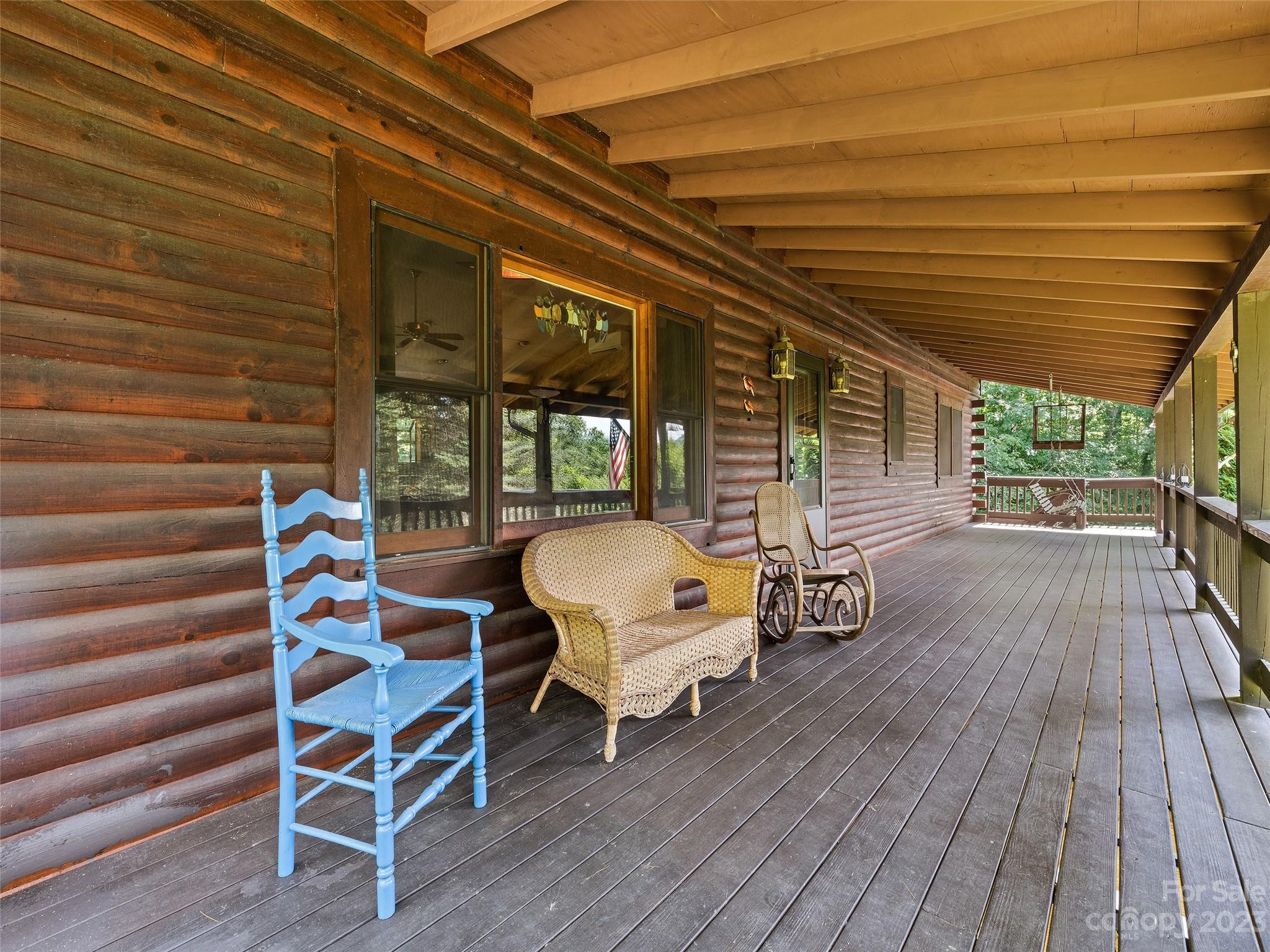 28 Honeybear Lane Clyde, NC 28721 - Photo 42 of 43 a view of a patio with table and chairs with wooden floor and fence