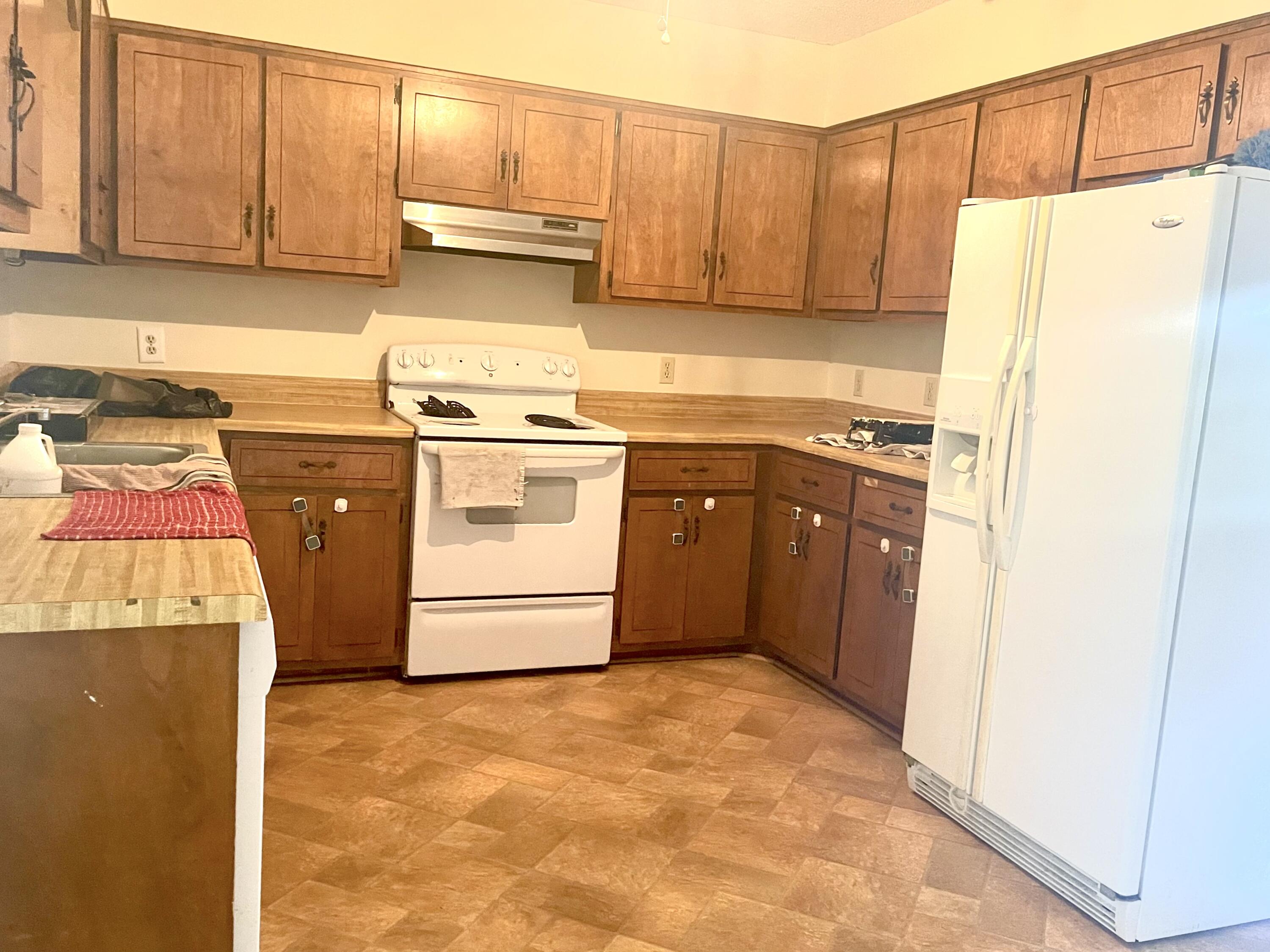 246 Ridge Lake Road Crestview, FL 32536 - Photo 11 of 17 a kitchen with a refrigerator sink stove and cabinets