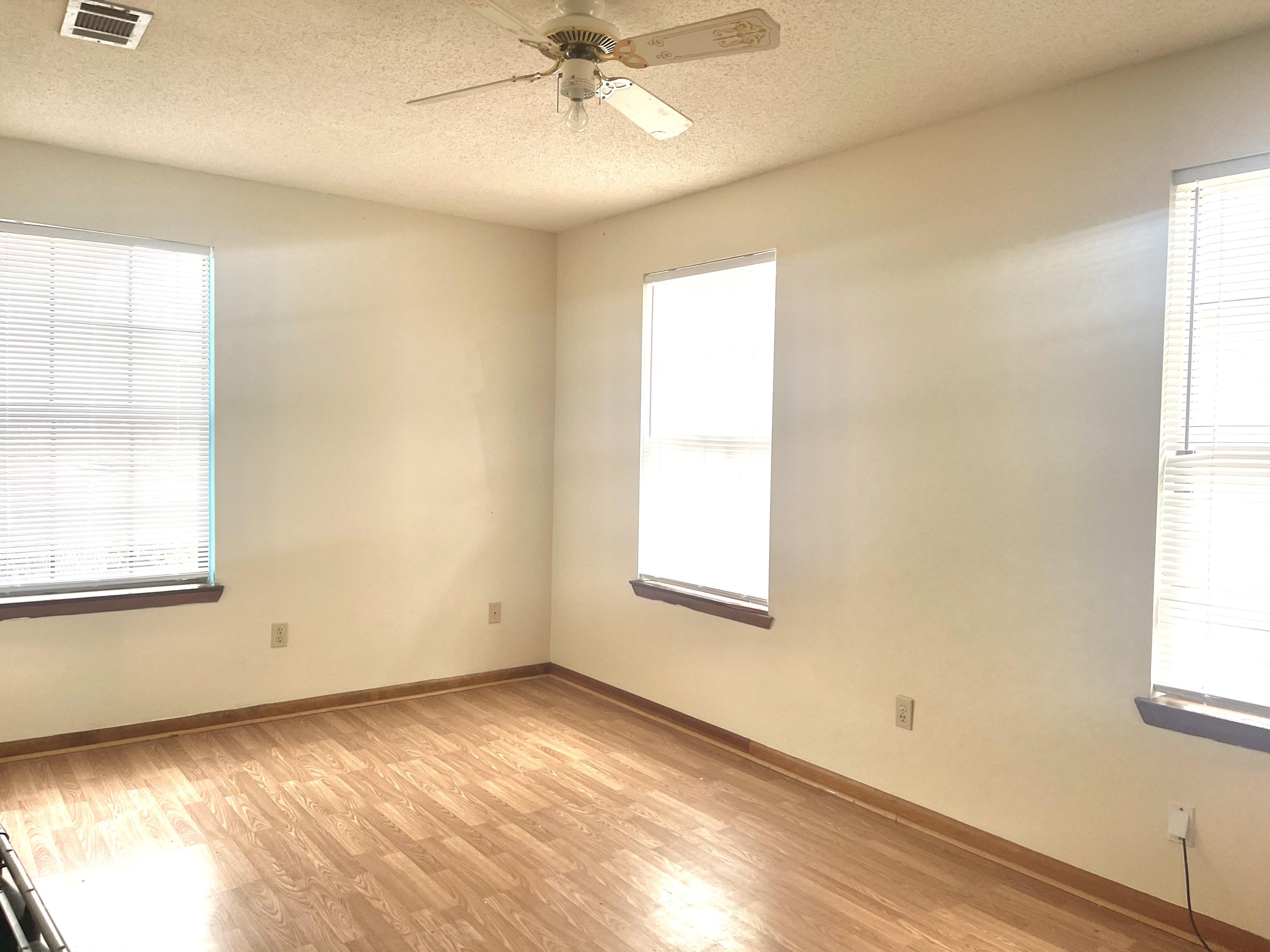 246 Ridge Lake Road Crestview, FL 32536 - Photo 17 of 17 an empty room with a window and wooden floor