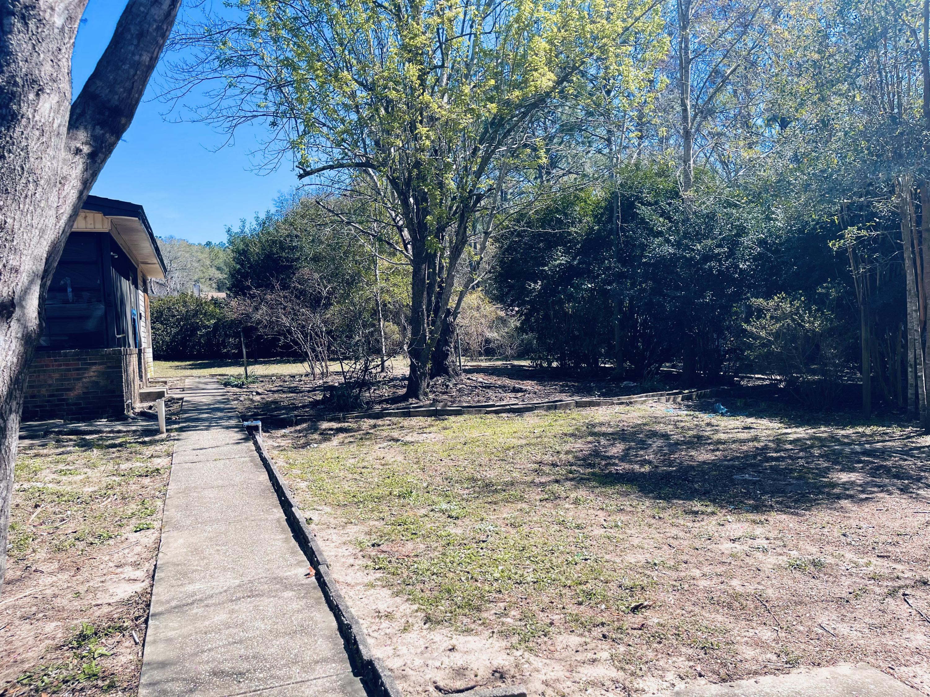 246 Ridge Lake Road Crestview, FL 32536 - Photo 6 of 17 a view of swimming pool with sitting area and trees around