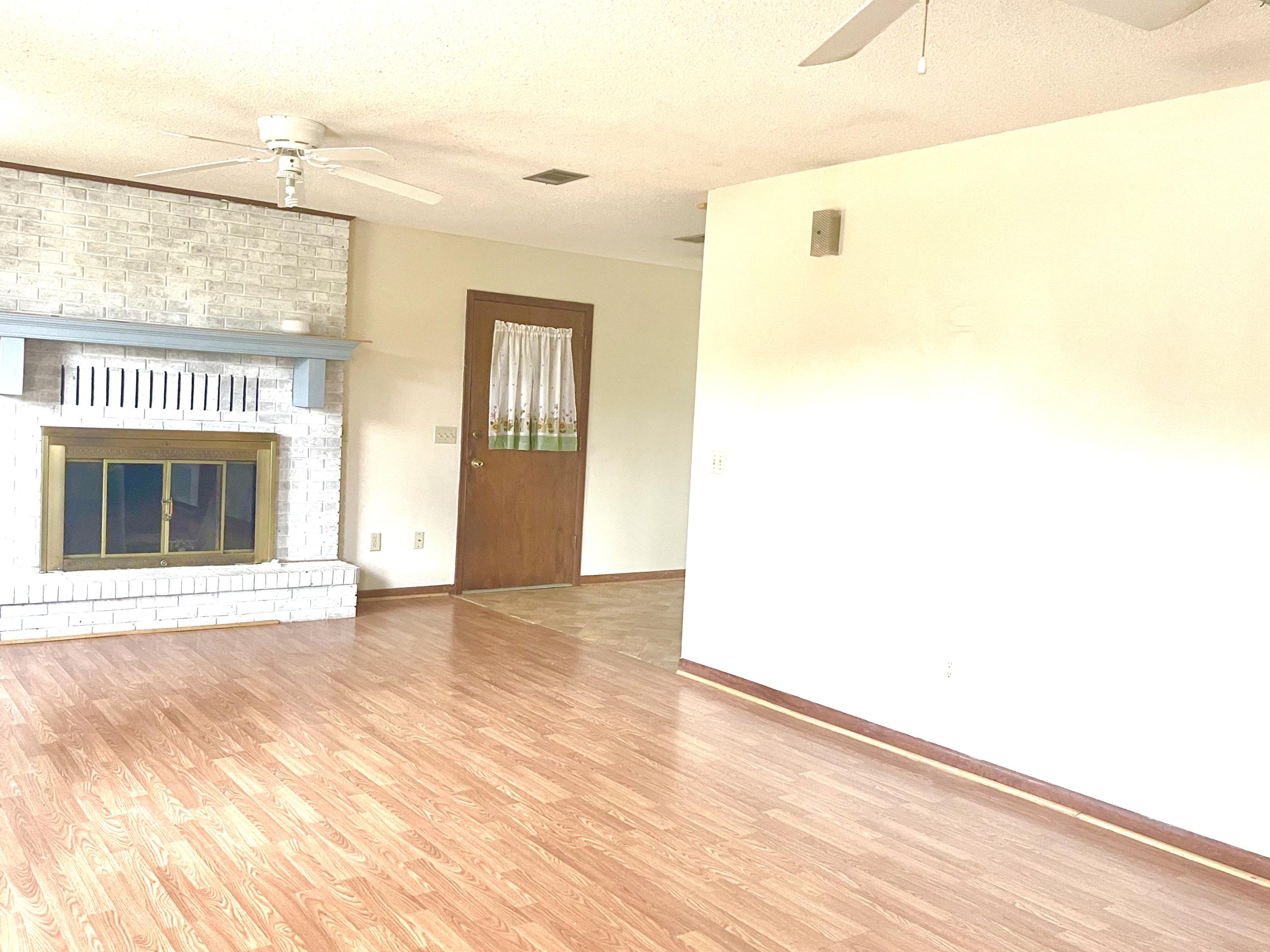 246 Ridge Lake Road Crestview, FL 32536 - Photo 7 of 17 a view of an empty room with wooden floor and a window