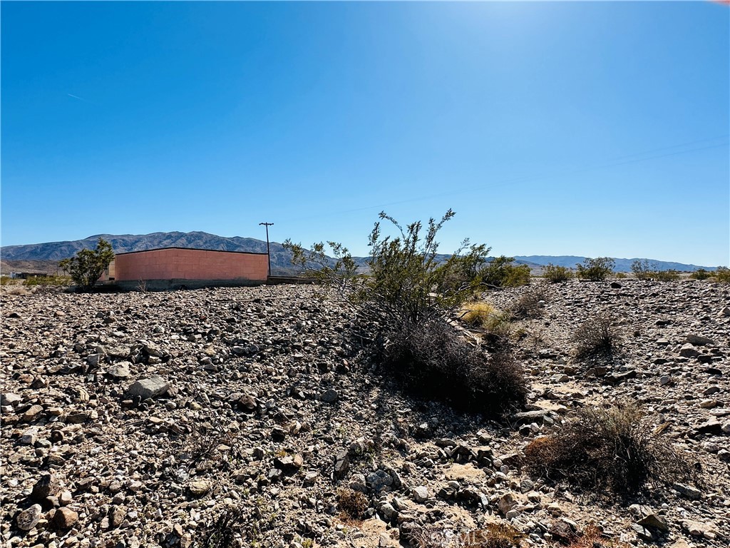 5 Sullivan Road Twentynine Palms, CA 92277 - Photo 10 of 21 a view of a dry yard with wooden fence