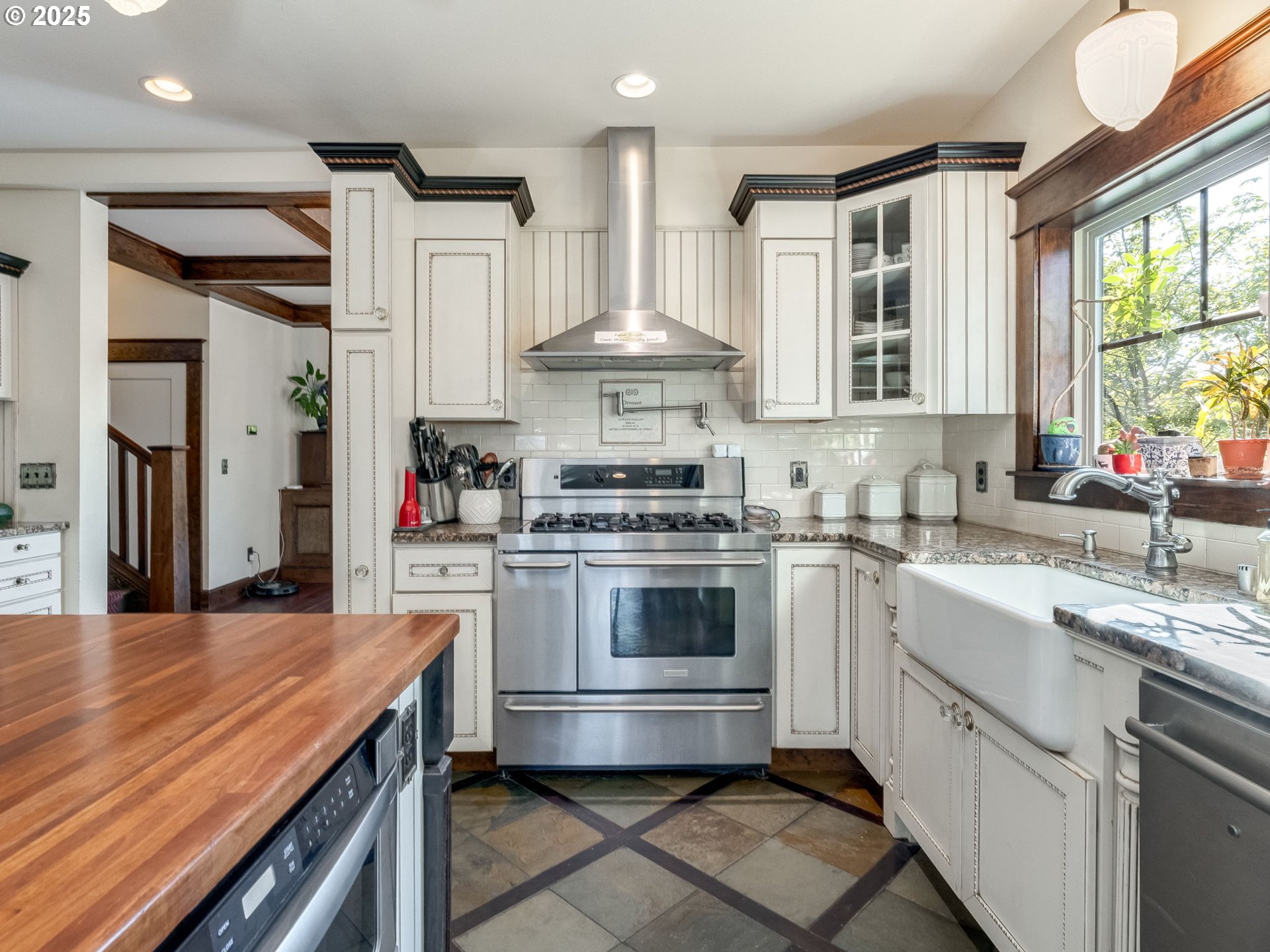 2400 H Street Vancouver, WA 98663 - Photo 16 of 48 a kitchen with stainless steel appliances a stove sink and cabinets