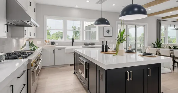 a kitchen with stainless steel appliances a sink a stove and a window
