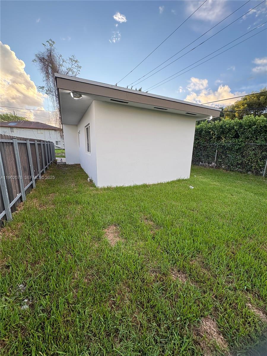 10020 Southwest 171st Street Miami, FL 33157 - Photo 16 of 18 a backyard of a house with lots of green space
