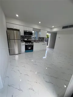 a kitchen with stainless steel appliances a refrigerator and a stove top oven