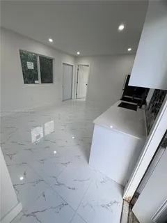a kitchen with granite countertop a stove and a refrigerator