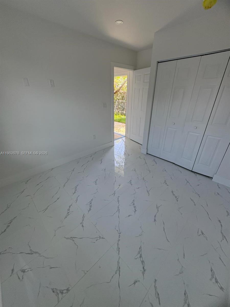 10020 Southwest 171st Street Miami, FL 33157 - Photo 9 of 18 a view of an empty room with a window