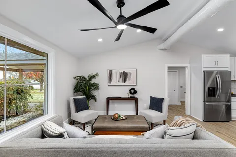 a living room with furniture and a large window