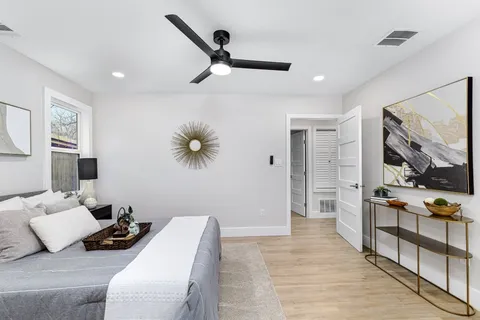 a bedroom with furniture and a large mirror