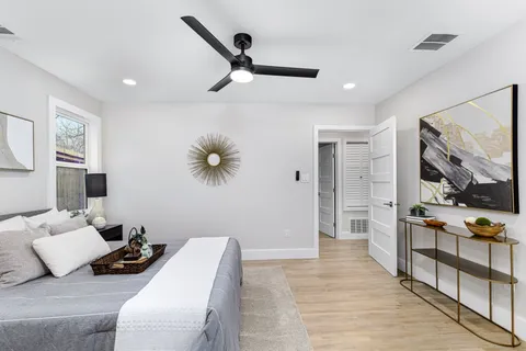 a bedroom with furniture and a large mirror