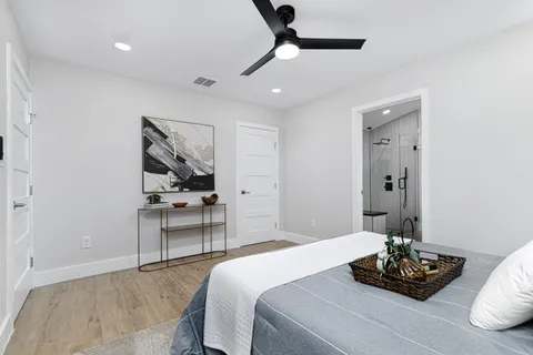 a bedroom with a bed and a table