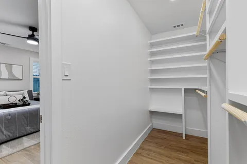 a view of walk in closet with empty racks