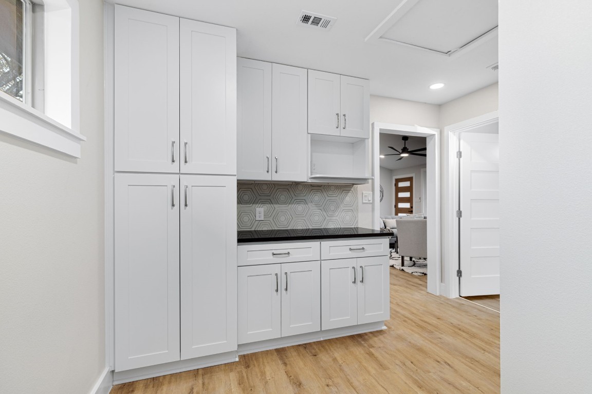 5605 Overbrook Drive Austin, TX 78723 - Photo 25 of 37 a kitchen with granite countertop white cabinets and stainless steel appliances