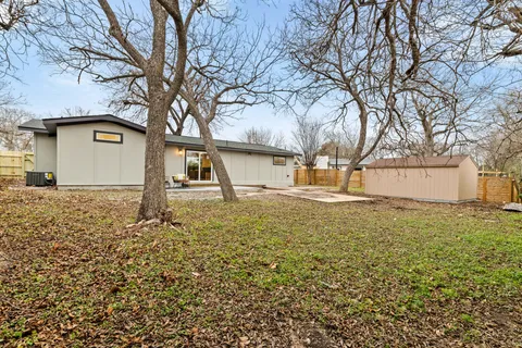 a house that has a tree in front of it