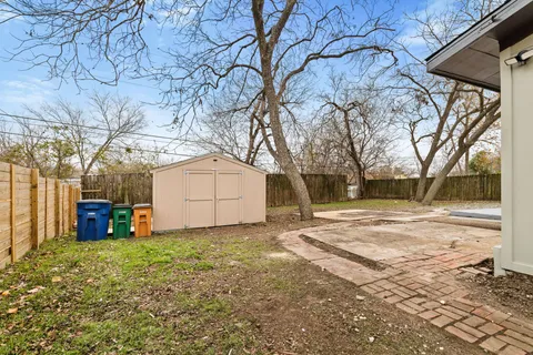 a view of a yard with large trees