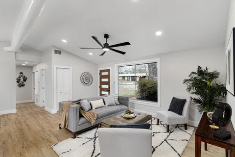 a dining room with furniture window and wooden floor