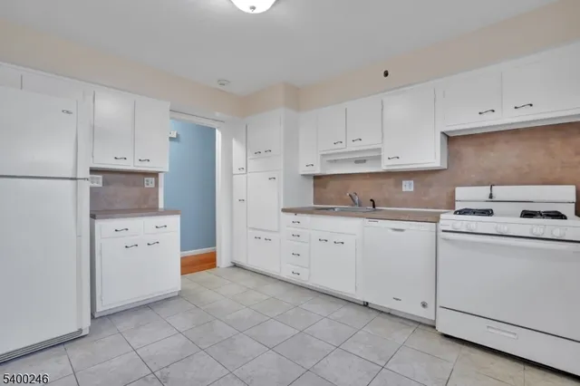 a kitchen with cabinets appliances and a sink