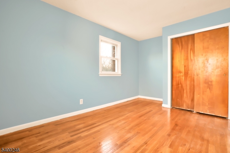726 Gates Terrace, Unit 2 Union, NJ 07083 - Photo 18 of 25 an empty room with wooden floor and windows