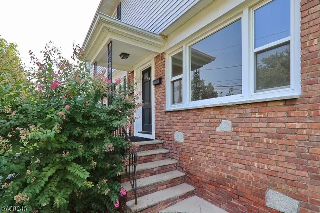 a front view of a house with trees