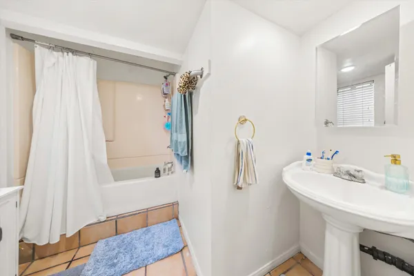 a bathroom with a sink a mirror and a bathtub