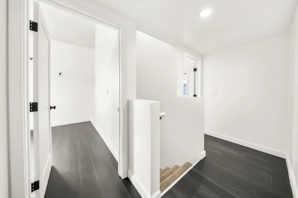 a view of a hallway with wooden floor