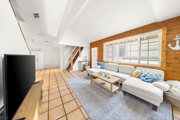 a living room with furniture and a floor to ceiling window