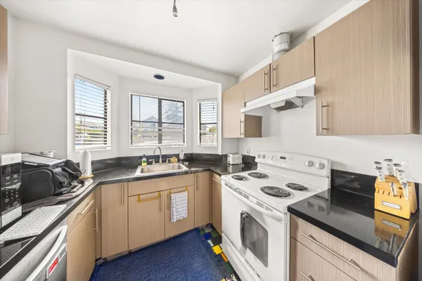a kitchen with a sink stove and cabinets