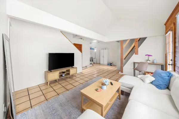 a living room with furniture and a flat screen tv