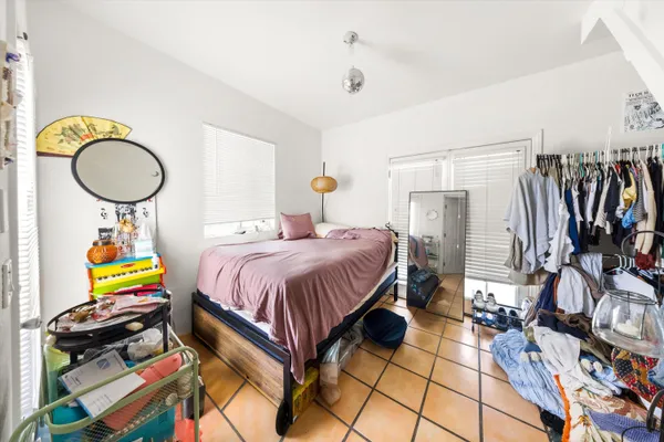 a spacious bedroom with a bed and a chandelier