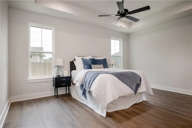a kitchen with kitchen island a sink a stove and chairs with wooden floor