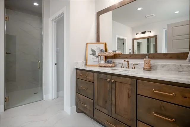 a bathroom with a double vanity sink and a mirror