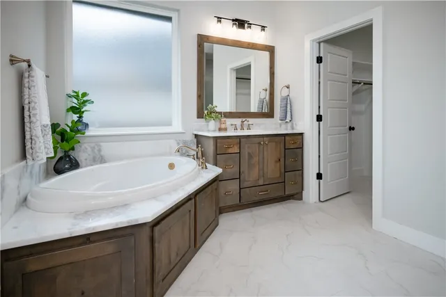 a bathroom with a granite countertop sink mirror and double