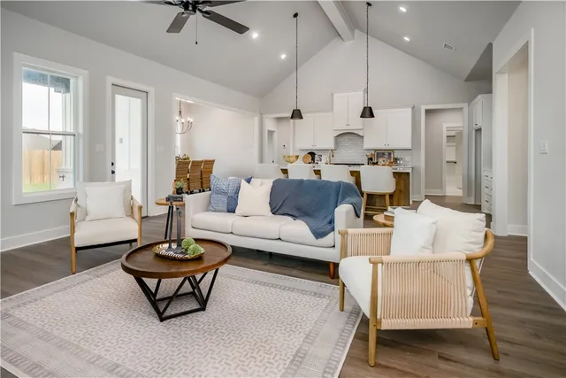 a living room with furniture a rug and a chandelier