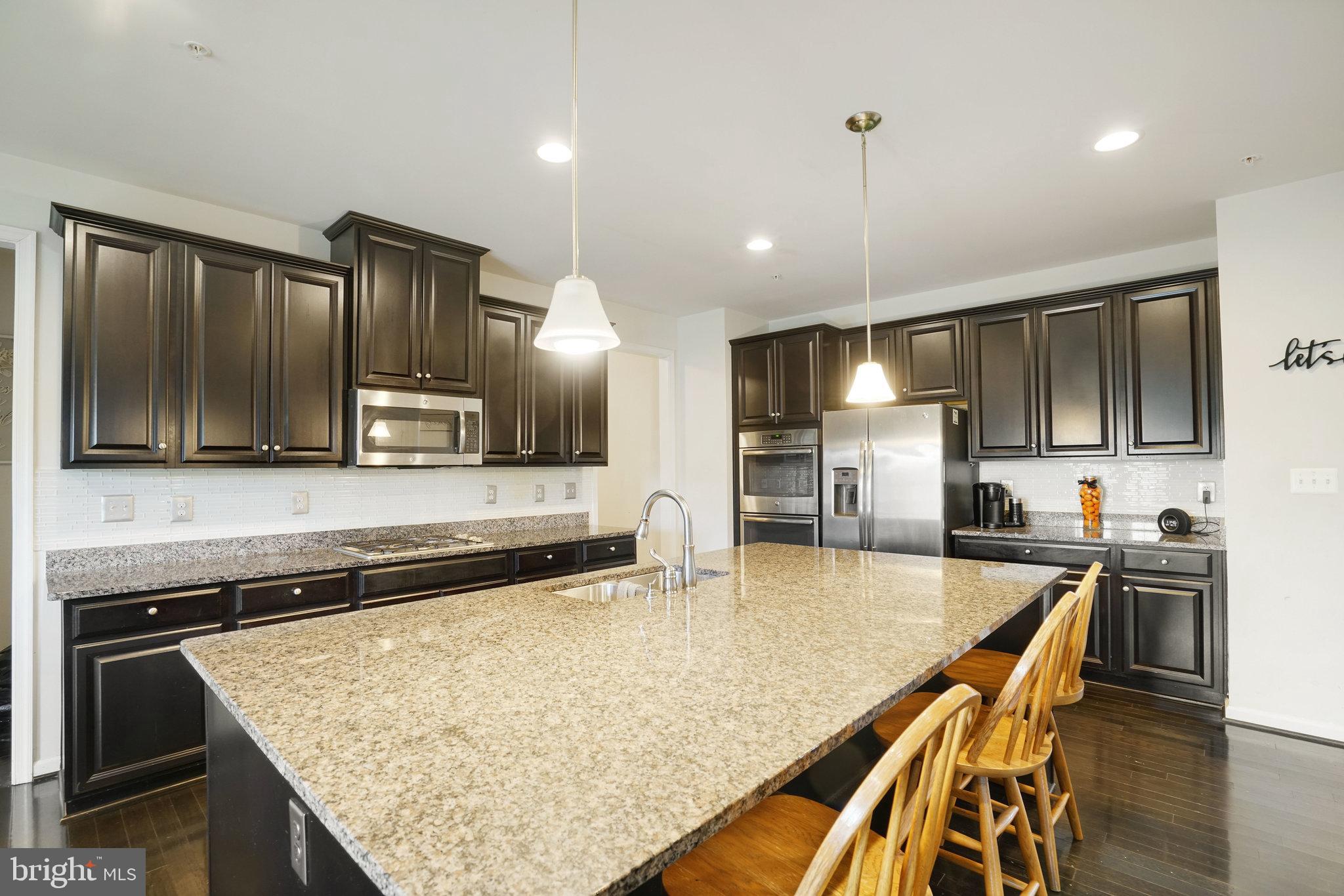 14333 Owings Avenue Brandywine, MD 20613 - Photo 3 of 16 a kitchen with stainless steel appliances granite countertop a sink refrigerator and cabinets