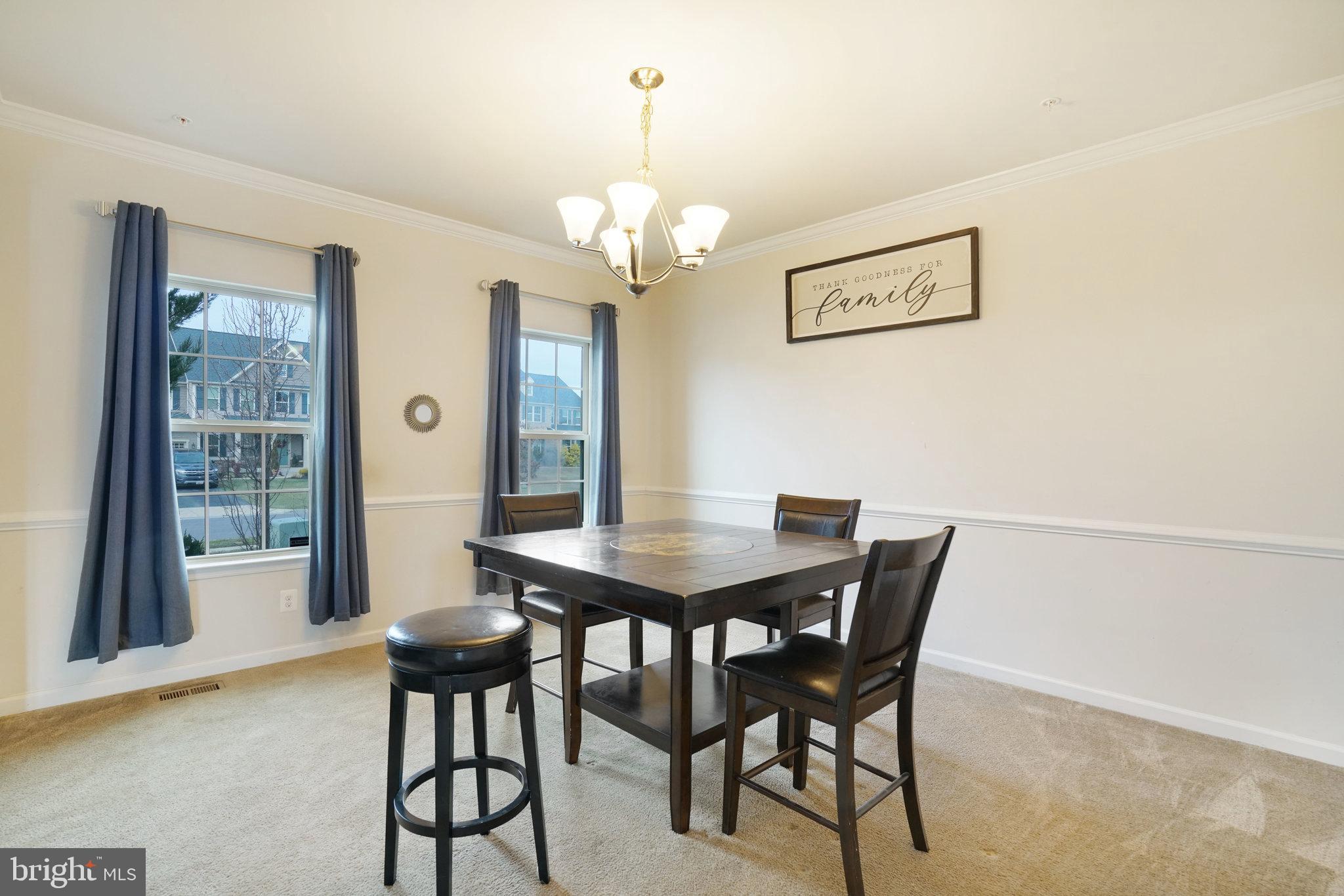 14333 Owings Avenue Brandywine, MD 20613 - Photo 5 of 16 a view of a dining room with furniture and a chandelier