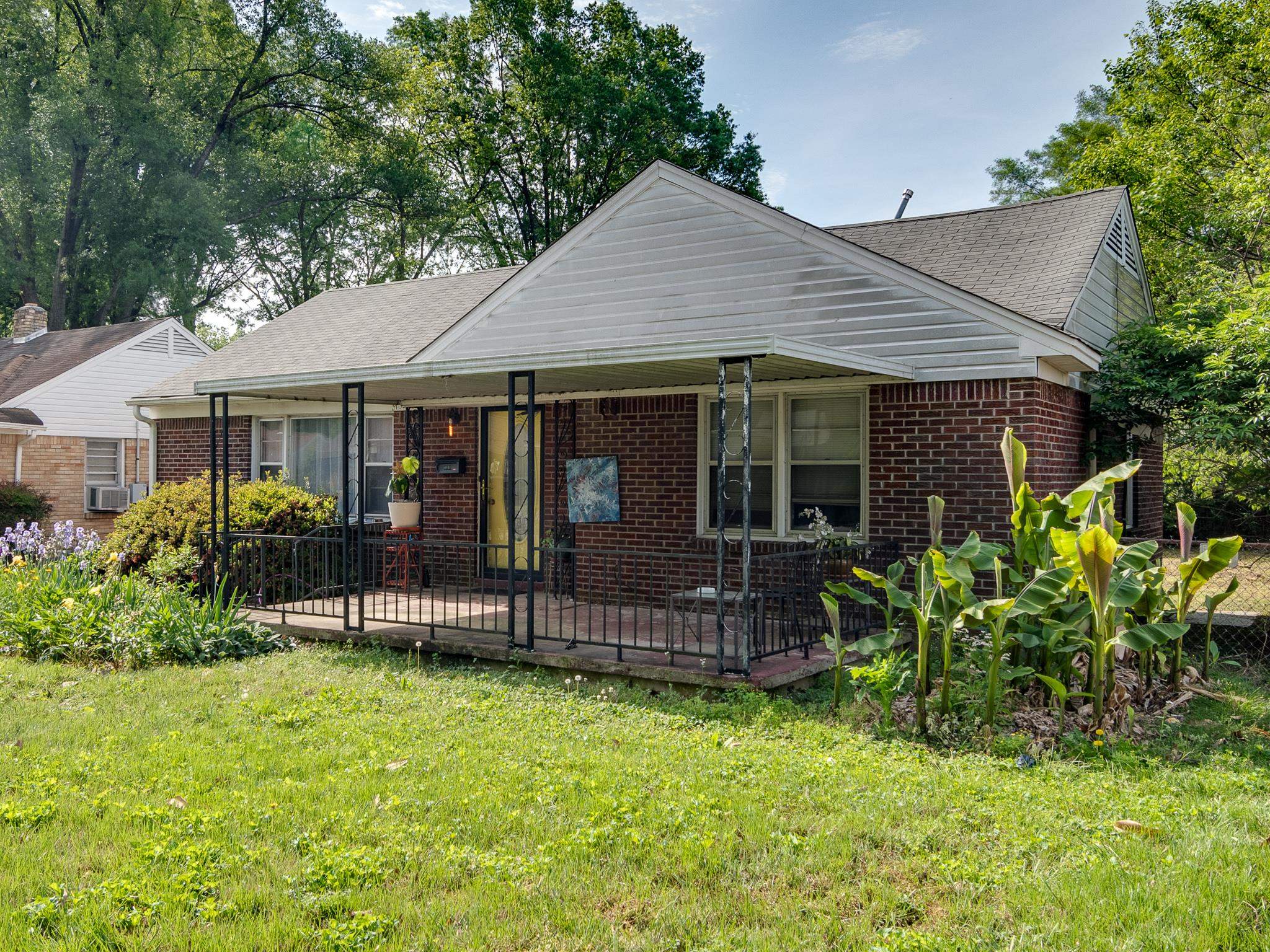 4661 Lynn Road Memphis, TN 38122 - Photo 1 of 32 a front view of a house with garden