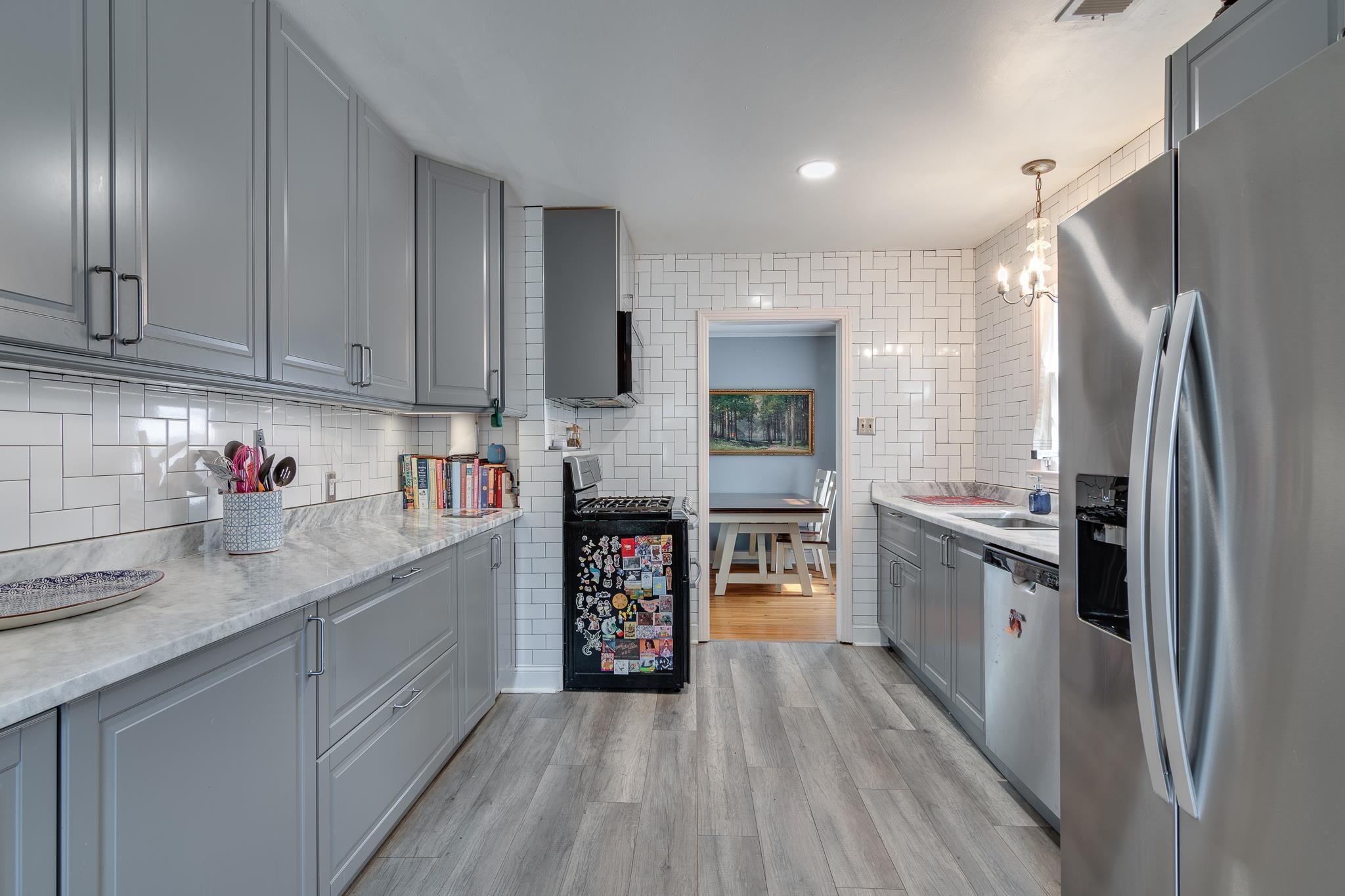 4661 Lynn Road Memphis, TN 38122 - Photo 15 of 32 a kitchen with granite countertop a refrigerator and a sink
