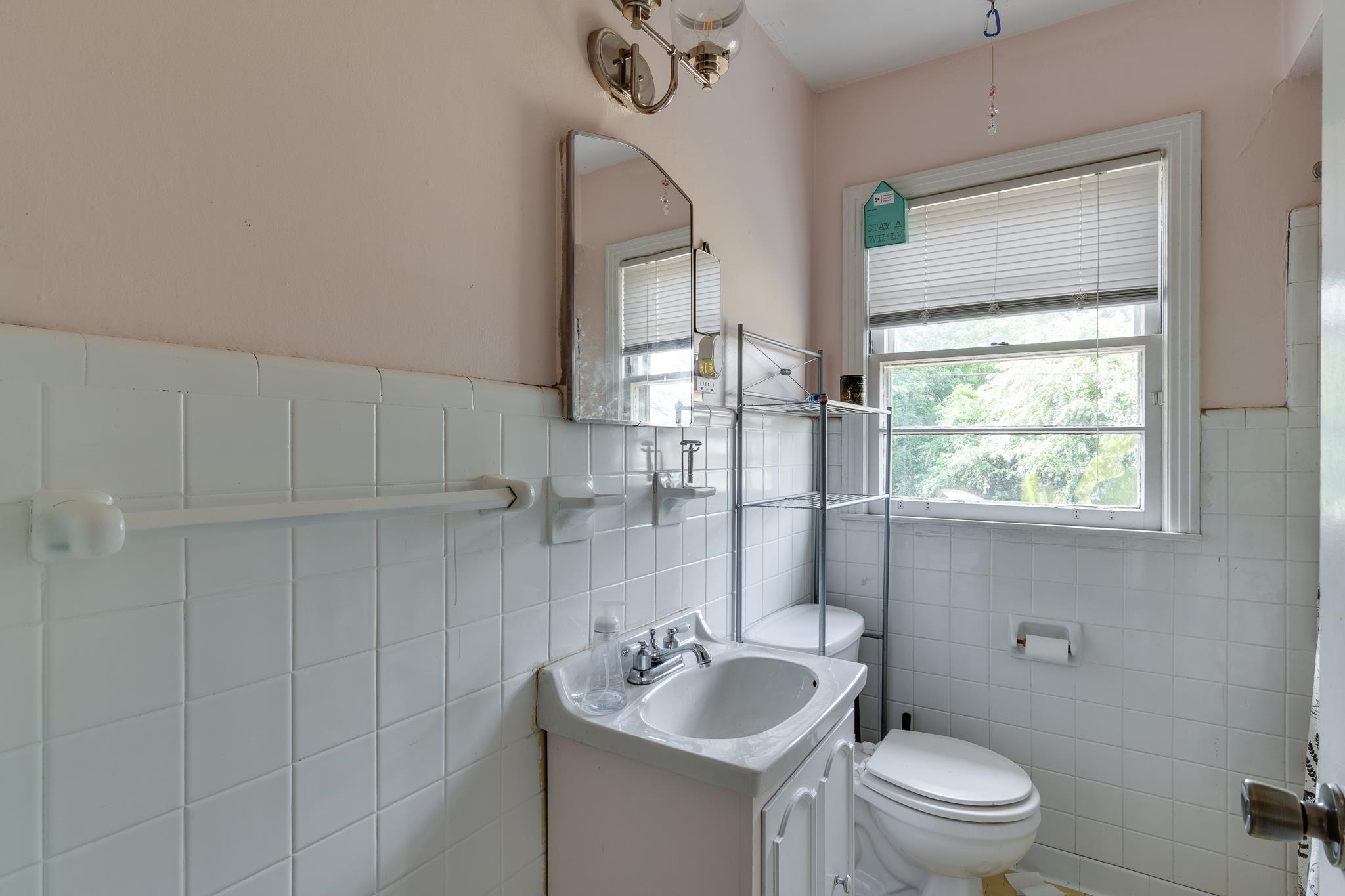 4661 Lynn Road Memphis, TN 38122 - Photo 25 of 32 a bathroom with a granite countertop sink a toilet a mirror and shower